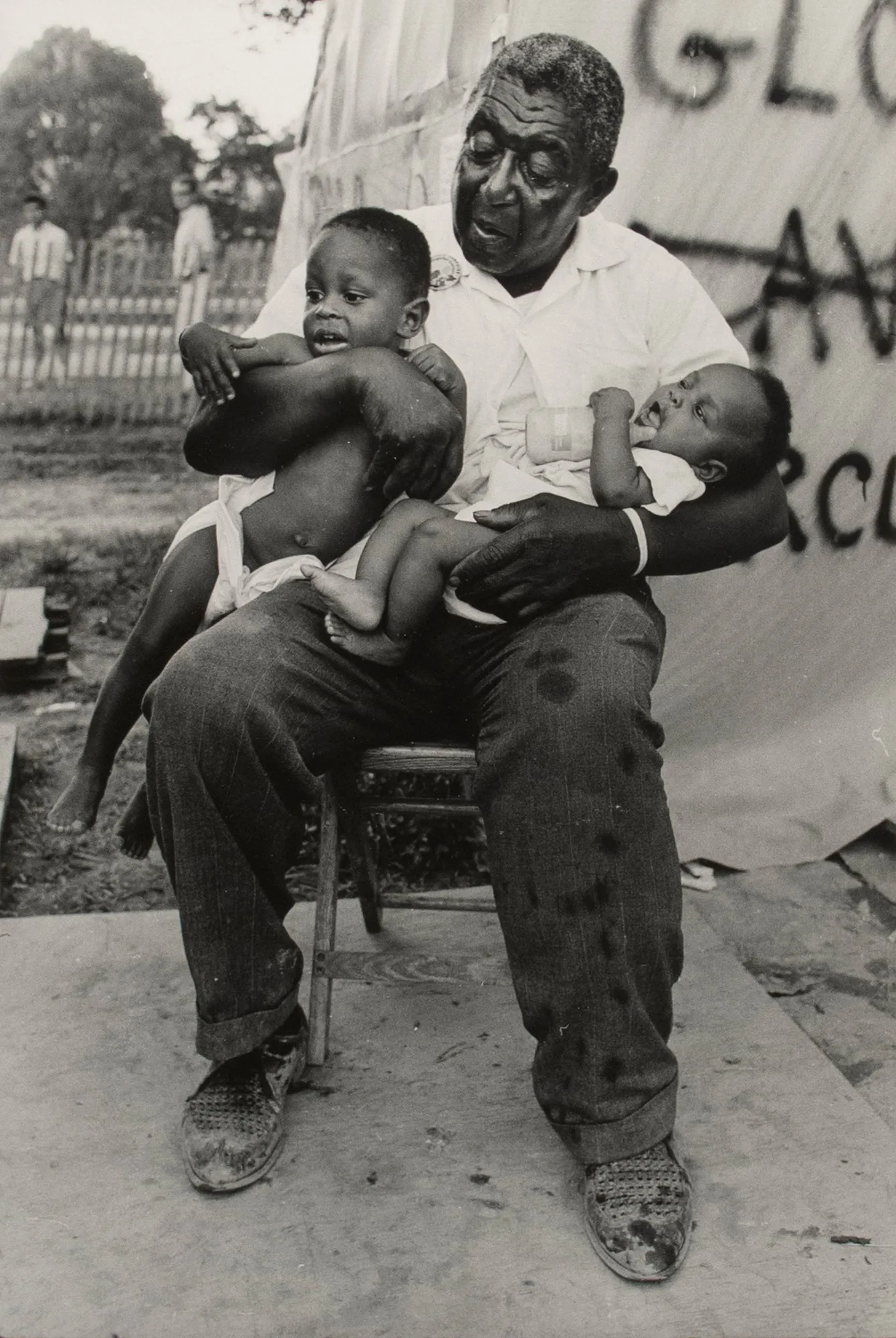 Untitled [A grandfather holds his two grandchildren in Resurrection City, Washington D.C.]